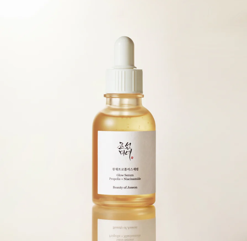 Skincare serum bottle with dropper on a light beige background