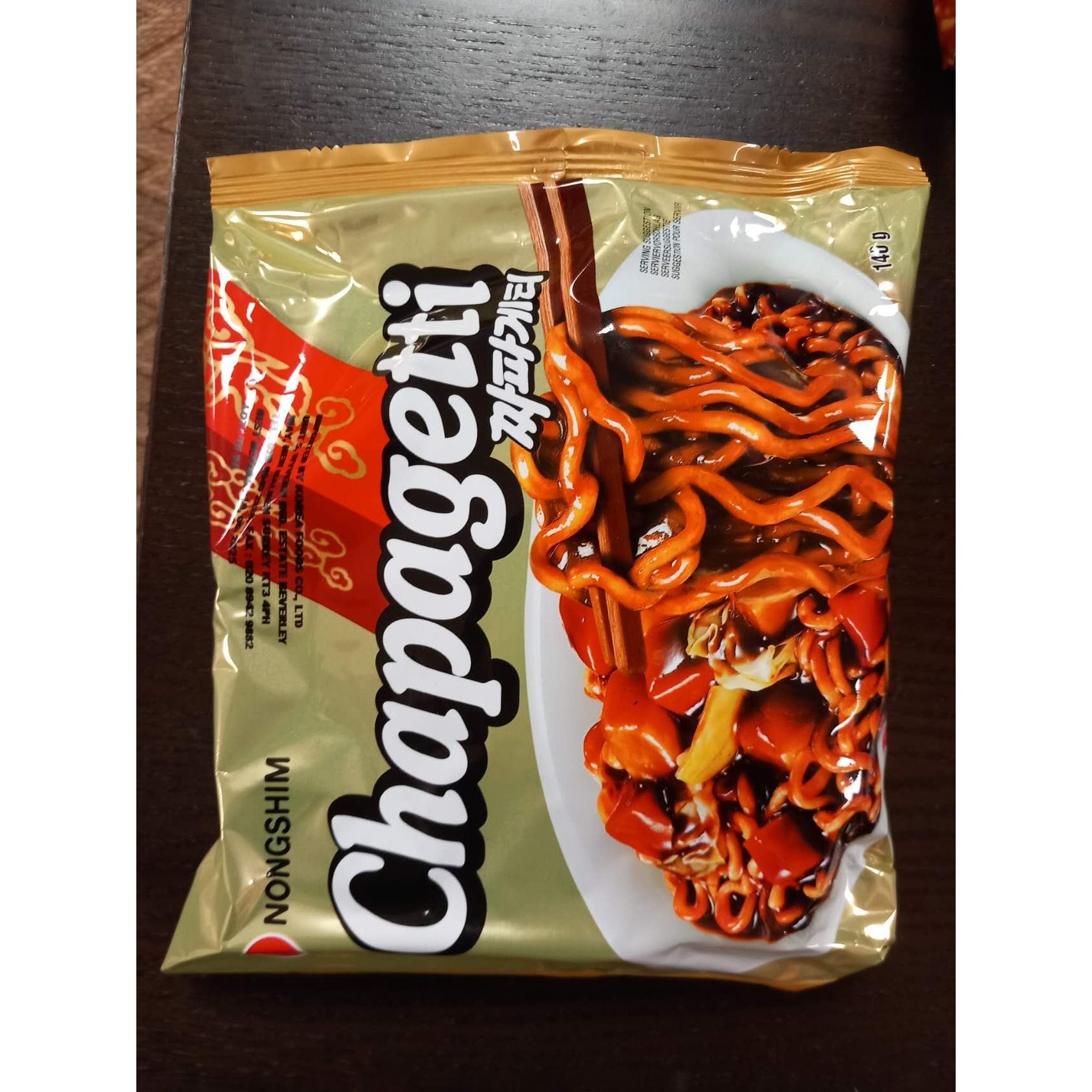 Packaged snack with 'Chapagetti' branding on a wooden surface