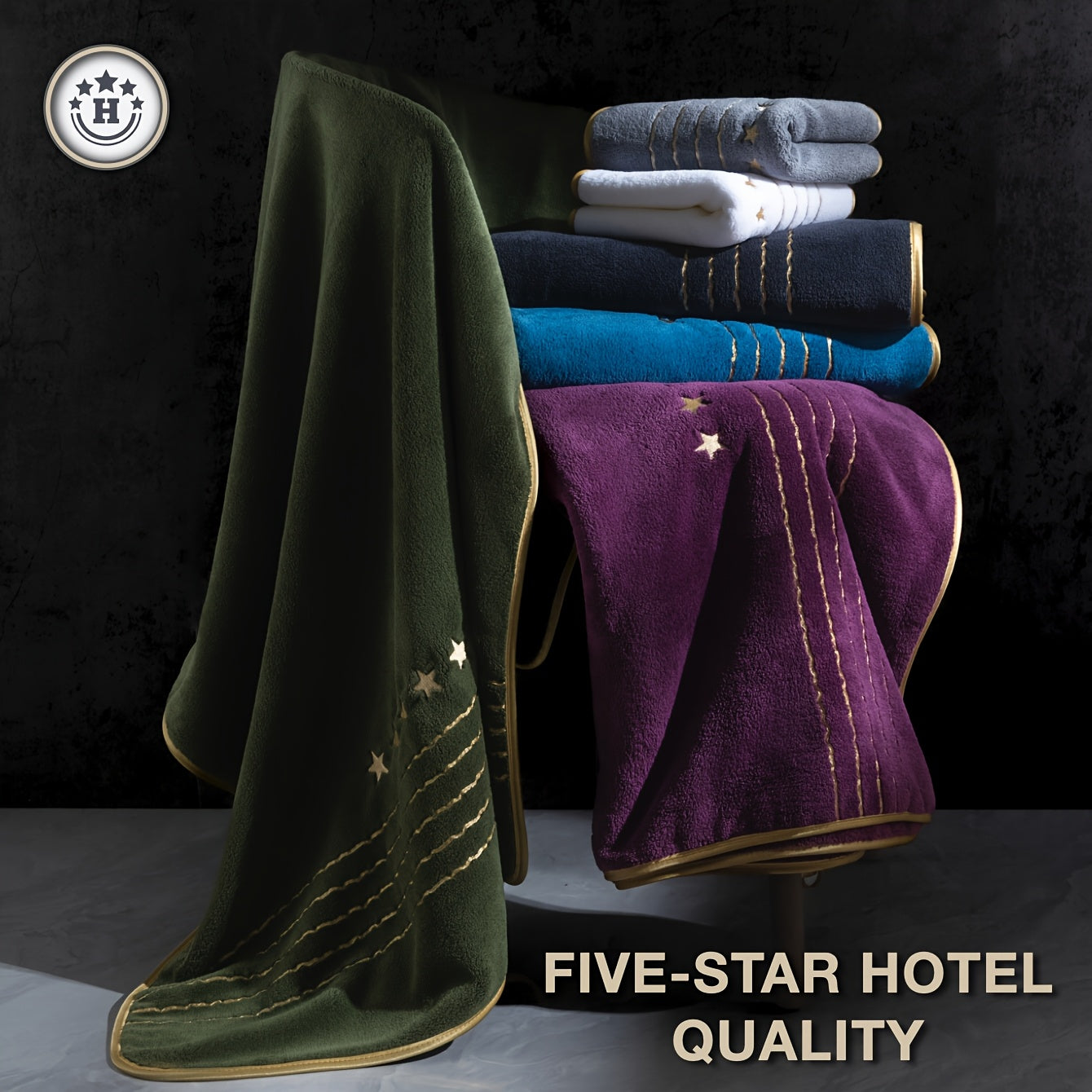 Stack of towels including green, purple, and blue with 'Five-Star Hotel Quality' text on a dark background.