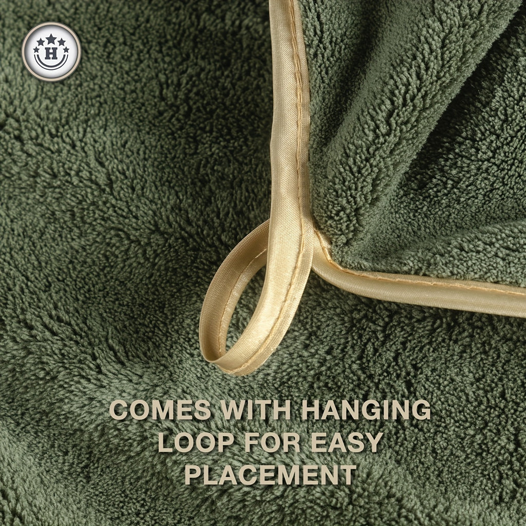 Green towel with a beige hanging loop on a green background