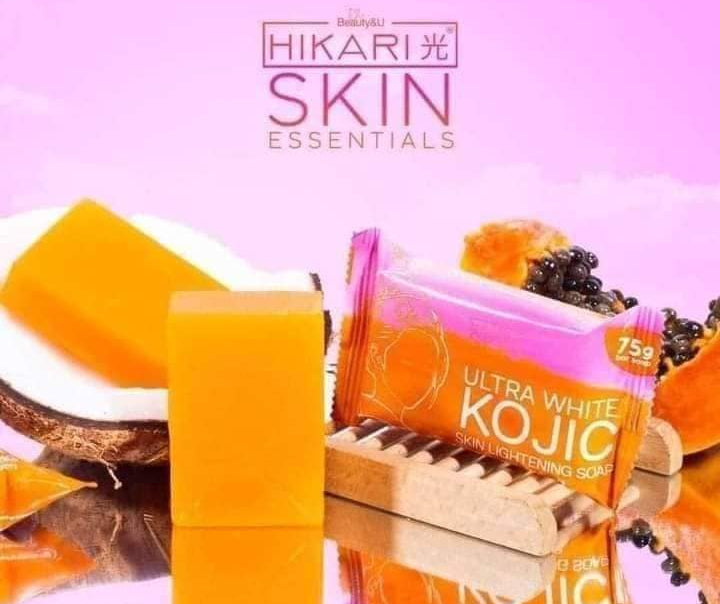 Orange soap bar with packaging labeled 'Ultra White Kojic' on a pink background, featuring Hikari Skin Essentials branding.