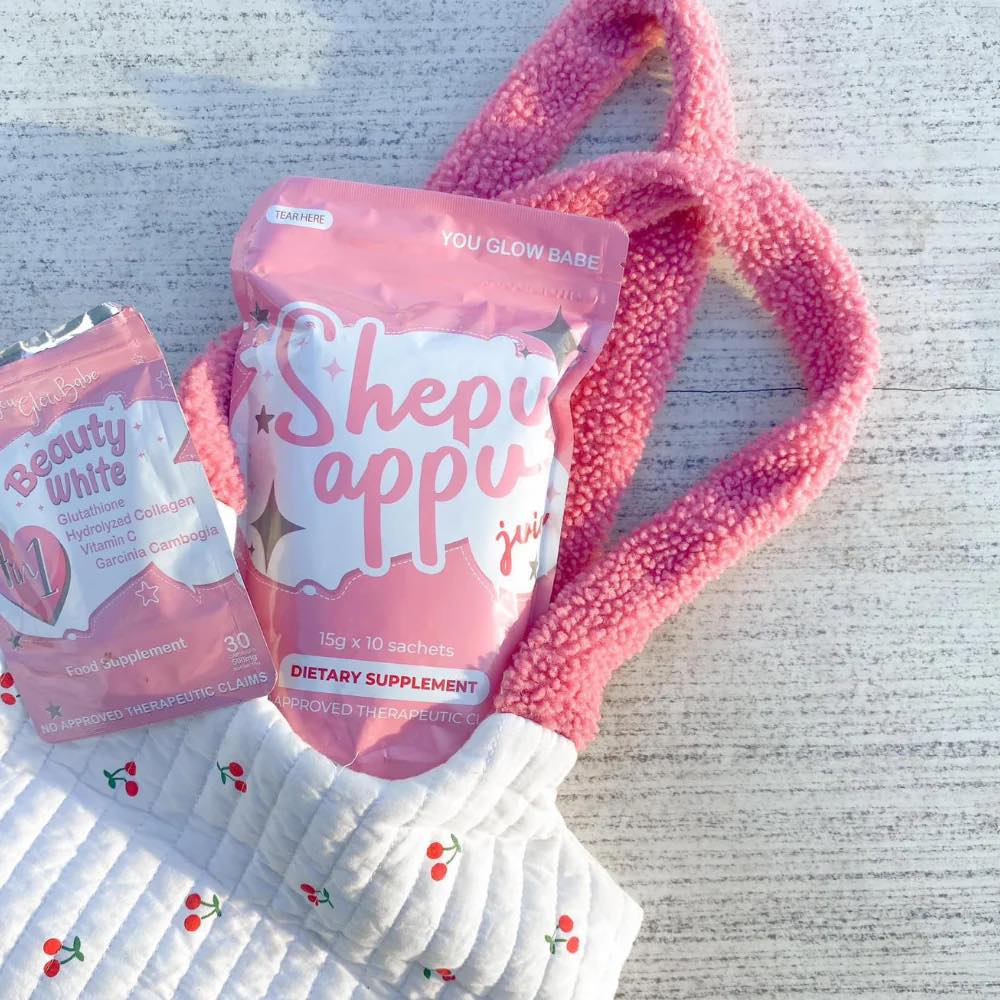 You Glow Babe Shepu appu juice in a pink packaging and a bag with Beauty white capsules packs in white grey backgroung