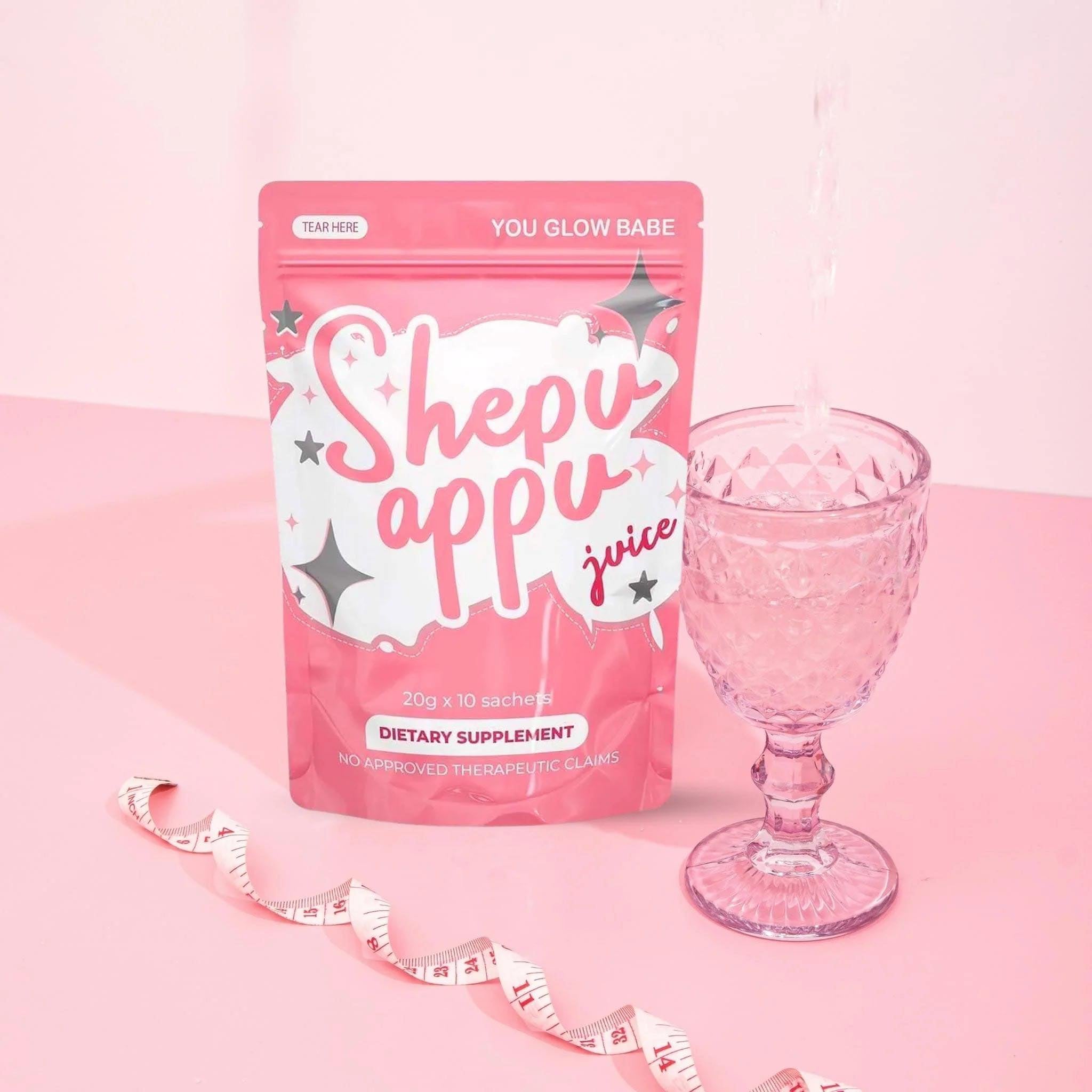 You glow babe Full pack and wine glass of juice with measuring tape in pink background