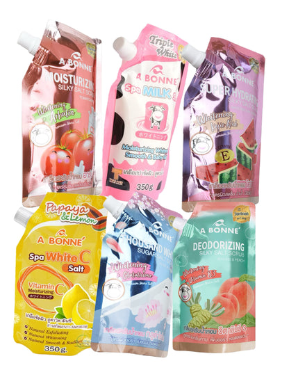 Multiple packets of A Bonne Spa Milk Salt Shower Salt Body Scrub in various flavors, each with a different color label.