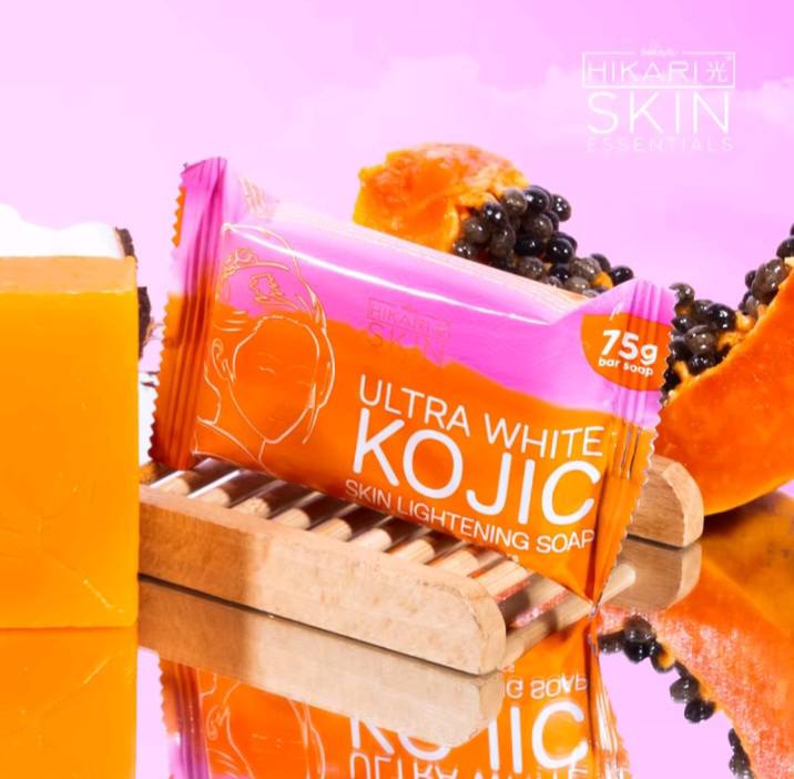 Ultra White Kojic soap packaging on a reflective surface with a pink background