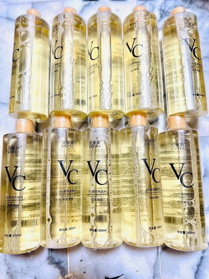 Multiple bottles of VC skincare product on a marble surface