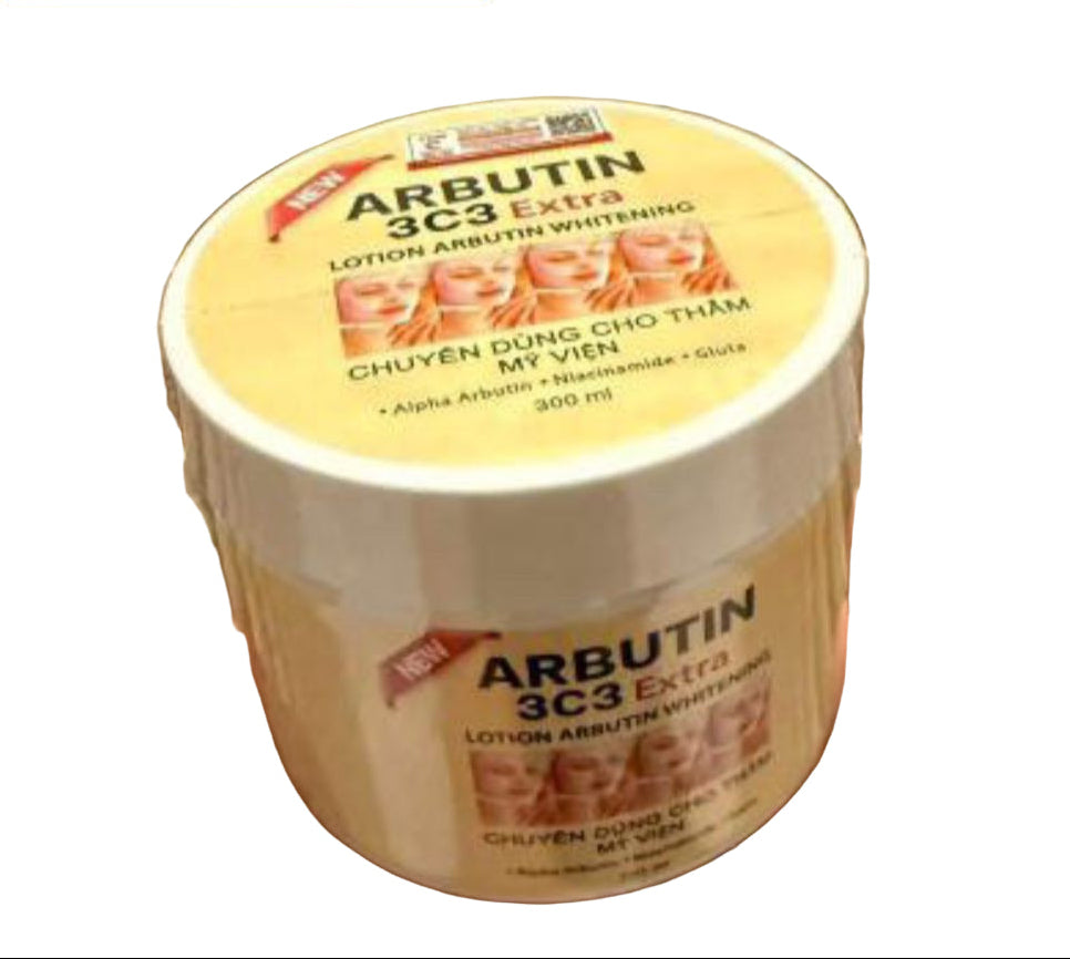 Jar of Arbutin 3C3 Extra lotion held by a hand against a wooden background