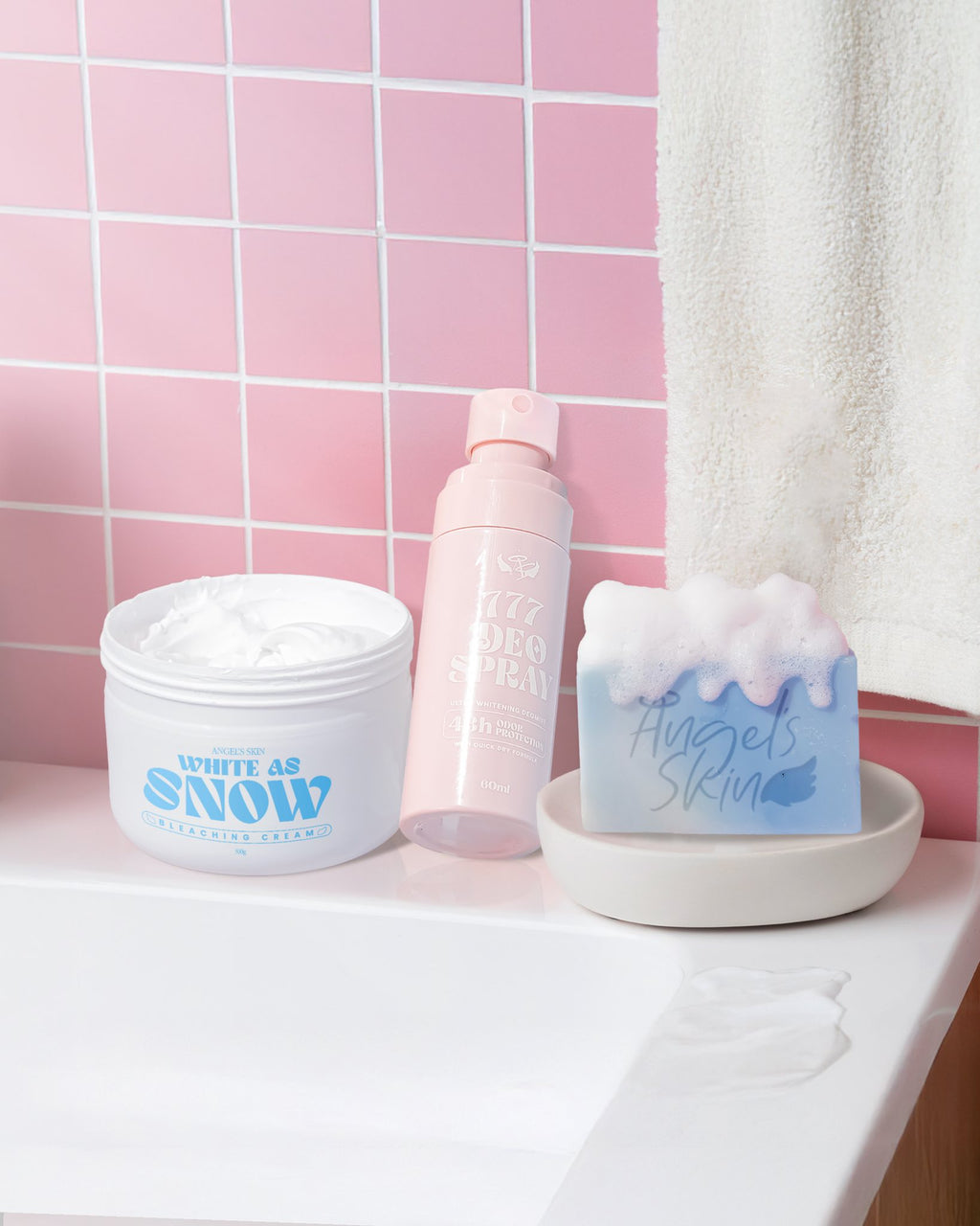 Bathroom counter with skincare products against a pink tiled wall