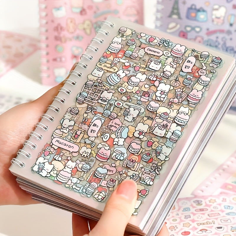 Notebook with colorful stickers featuring cartoon characters and food items held by a hand.