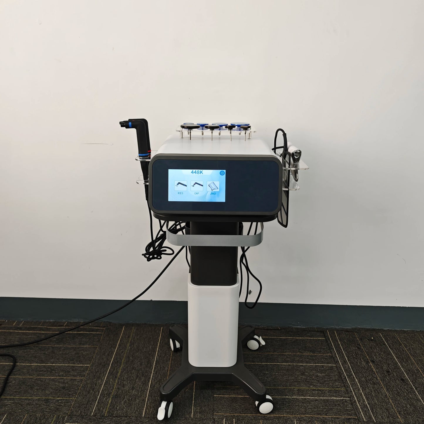 Medical device with digital display on a gray floor against a white wall