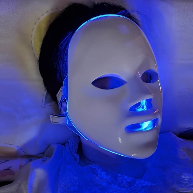 Person wearing a LED face mask with blue light on a neutral background