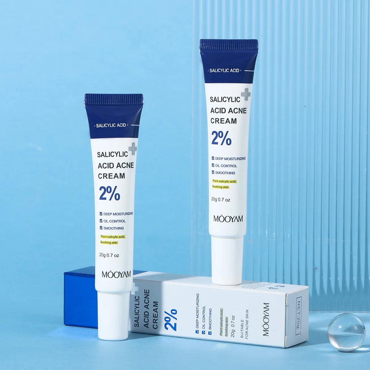 Two tubes of Mooyam Salicylic Acid Acne Cream on a blue background