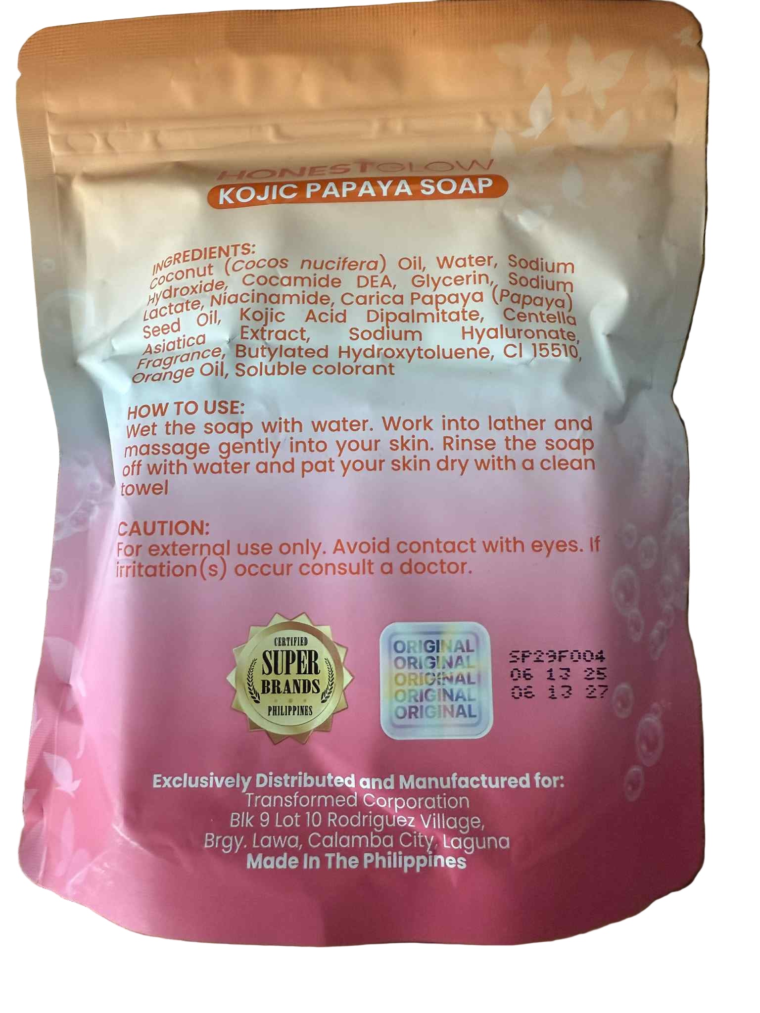 Kojic Papaya Soap packaging with text and branding on a wooden surface