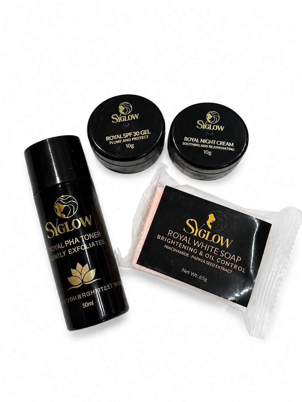 A skincare set from Siglow on a white background, including a black Royal Pha Toner bottle, two black jars of Royal SPF 30 Gel and Royal Night Cream, and a packaged black Royal White Soap block.