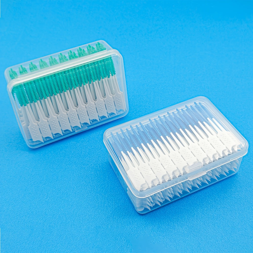 Two clear plastic containers with toothbrushes on a blue background
