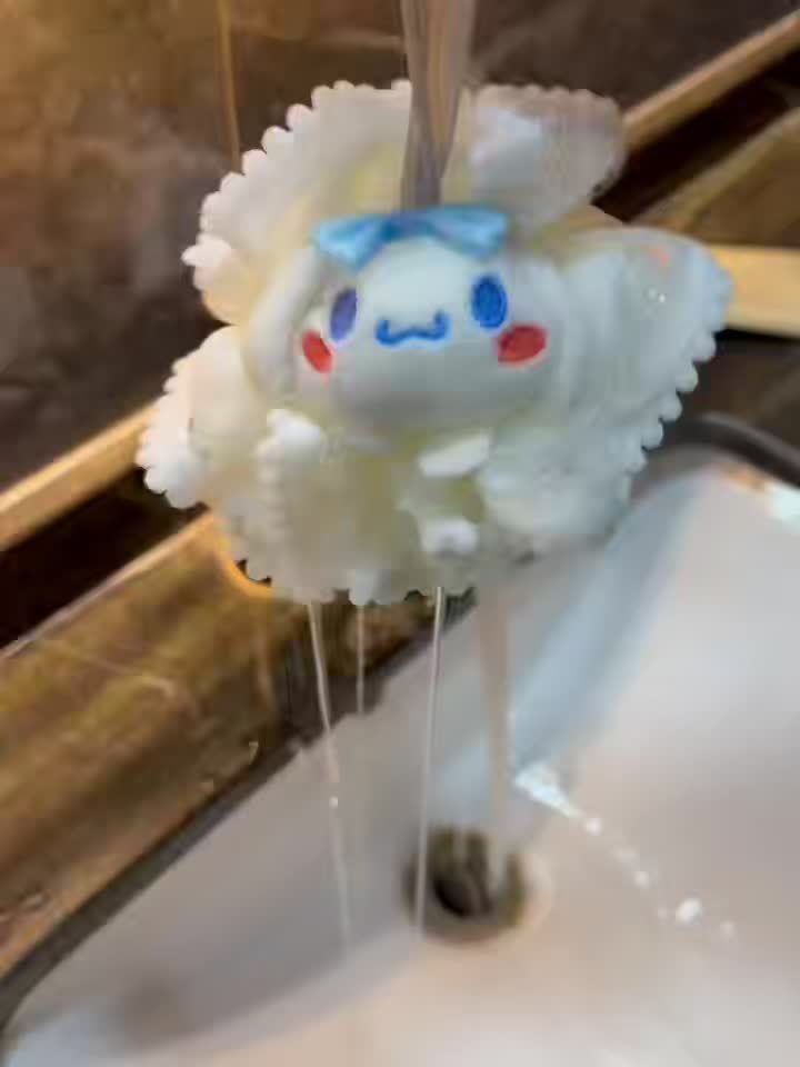 Cartoon character soap dispenser with water flowing from it