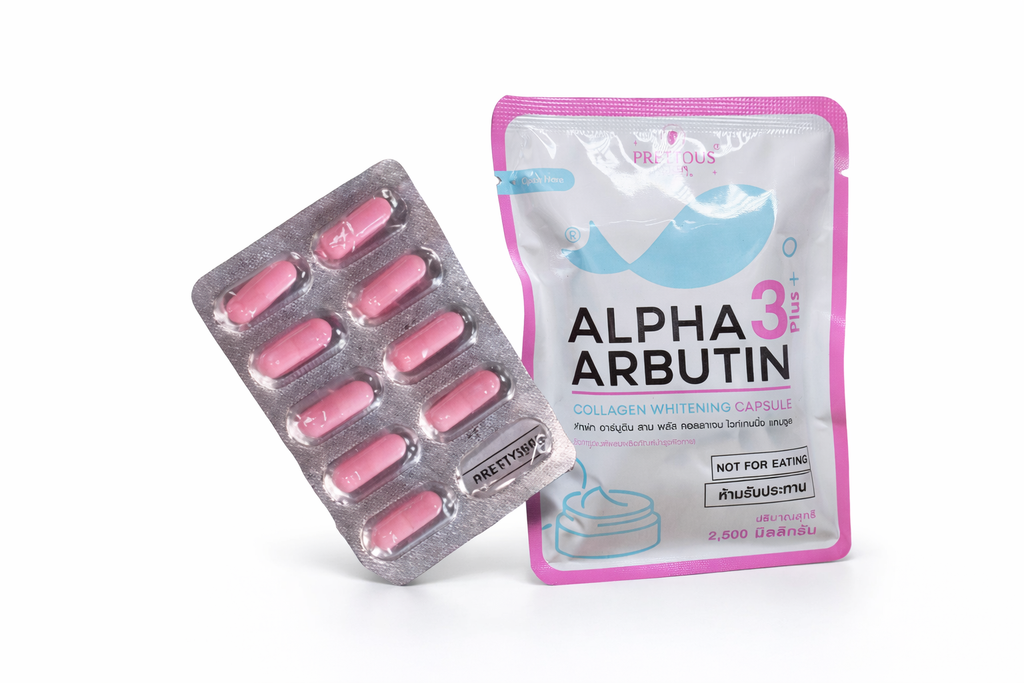 Pink capsules in a blister pack and Alpha Arbutin packaging on a white background