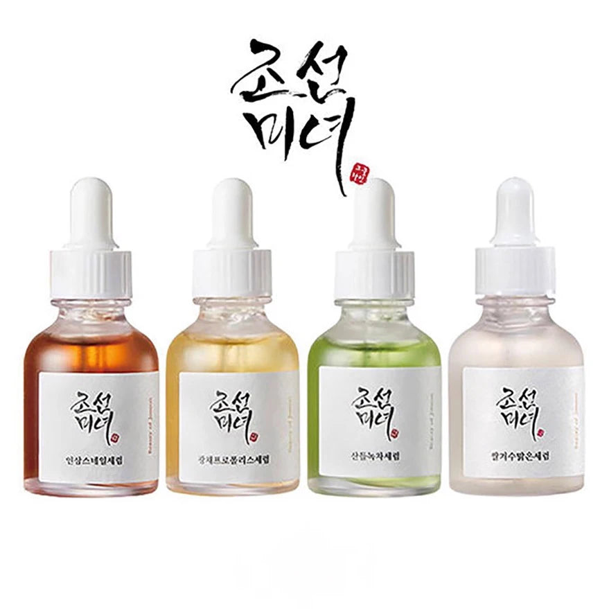Four dropper bottles with different colored liquids on a white background, featuring Korean text.