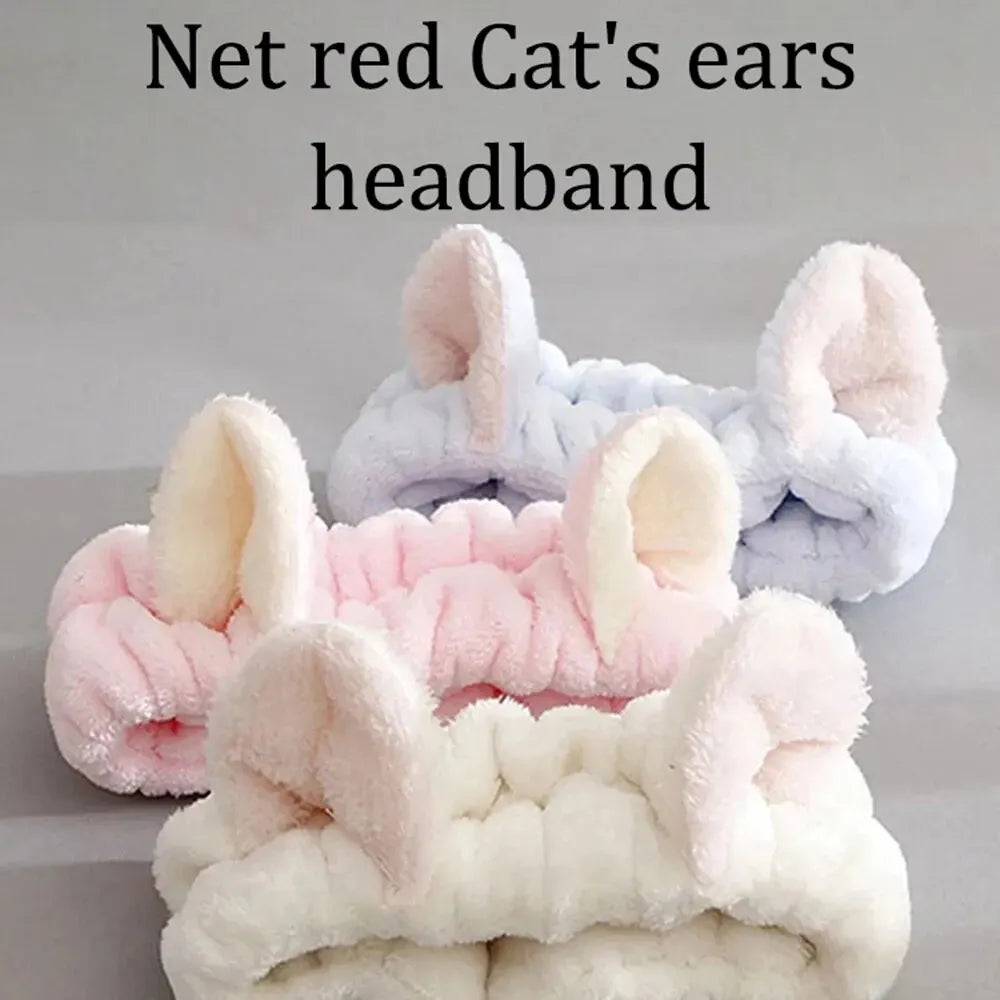 Three cat ear headbands in pink, white, and gray on a light gray background.