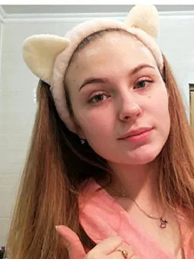 Person wearing a headband with cat ears indoors