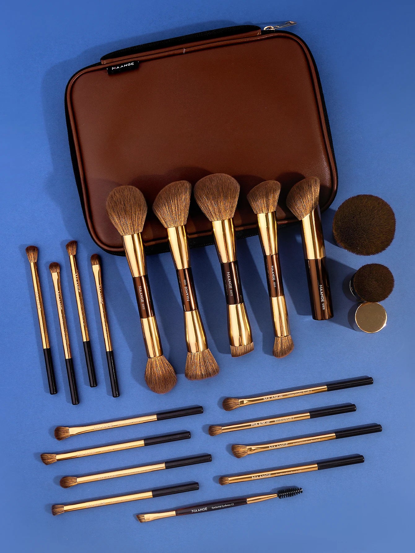 Set of makeup brushes with a brown case on a blue background