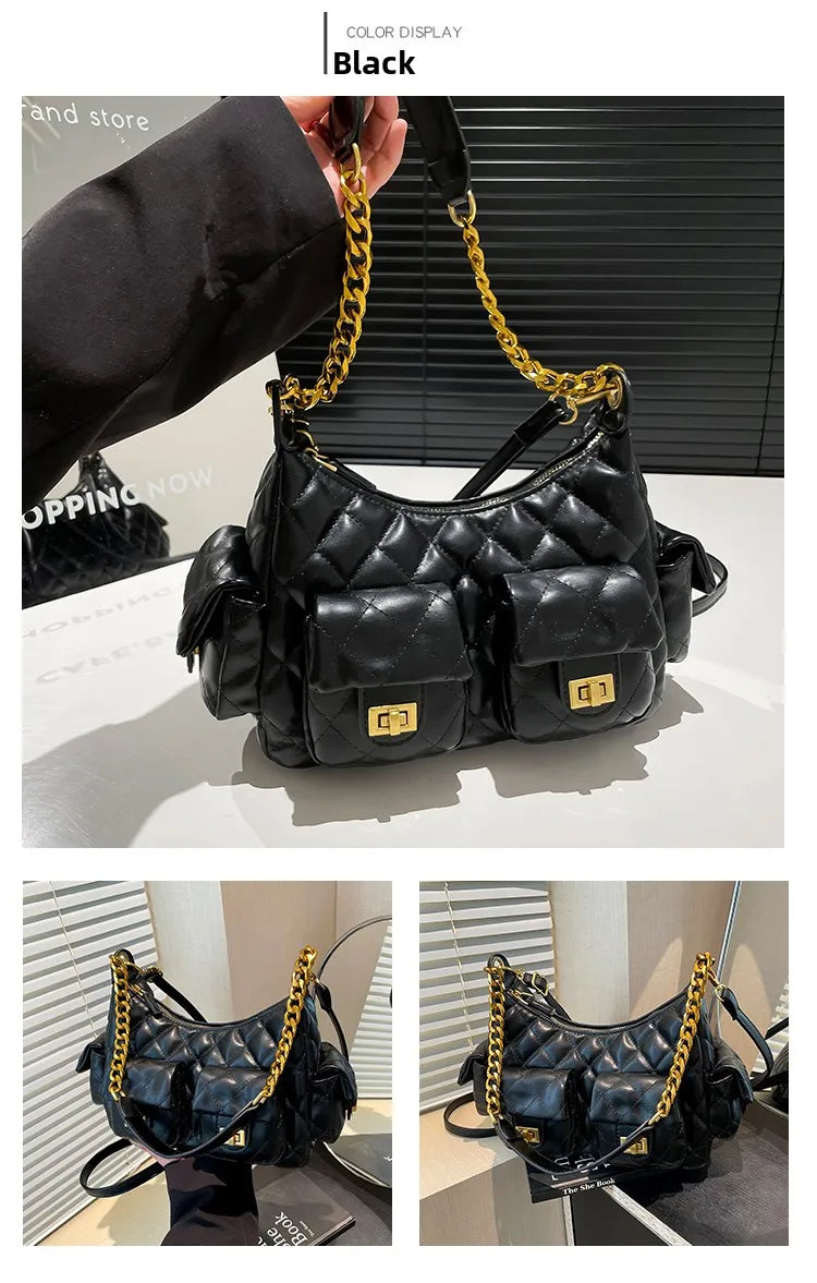 Black quilted handbag with gold chain strap on a white surface.