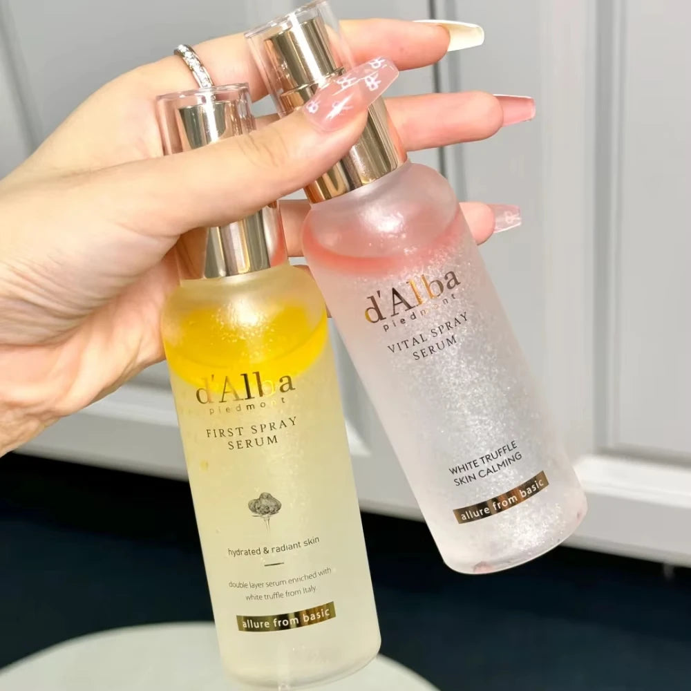 Two skincare serum bottles held by a hand with a neutral background