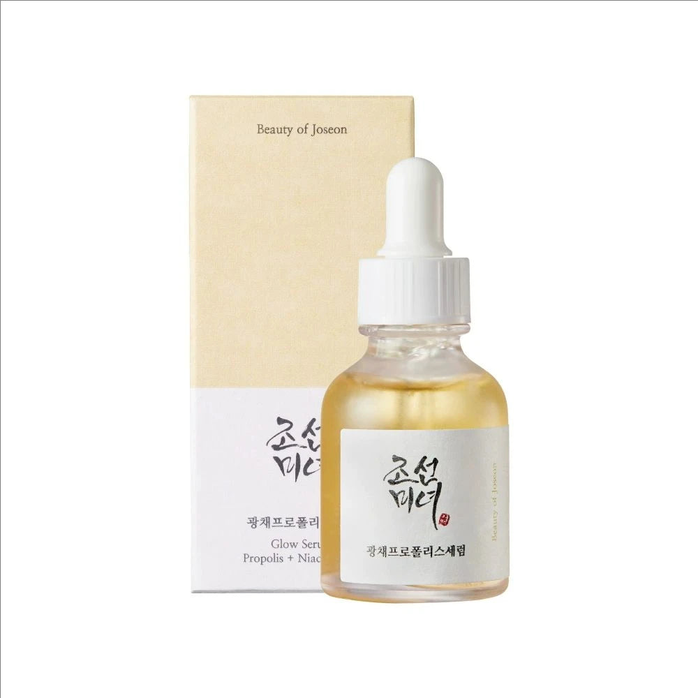 Skincare serum bottle with dropper and packaging on a white background