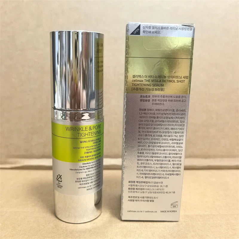 Skincare bottle with green label and silver cap next to its packaging on a beige background