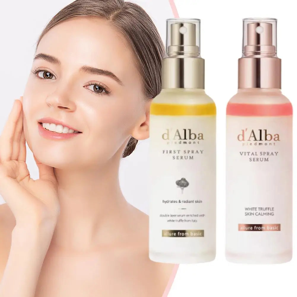 Woman touching her face with two d'Alba skincare products displayed.