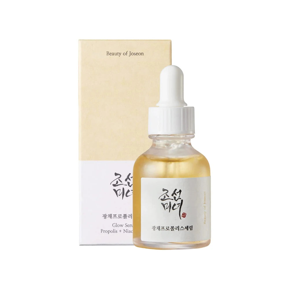Skincare serum bottle with dropper and packaging on a white background