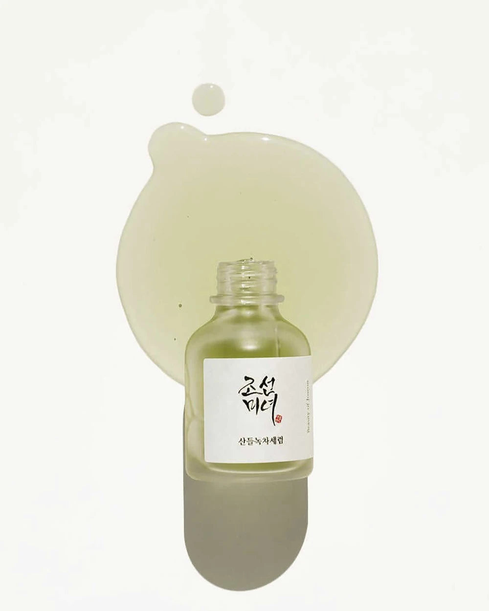 Bottle of green liquid with a label on a white background