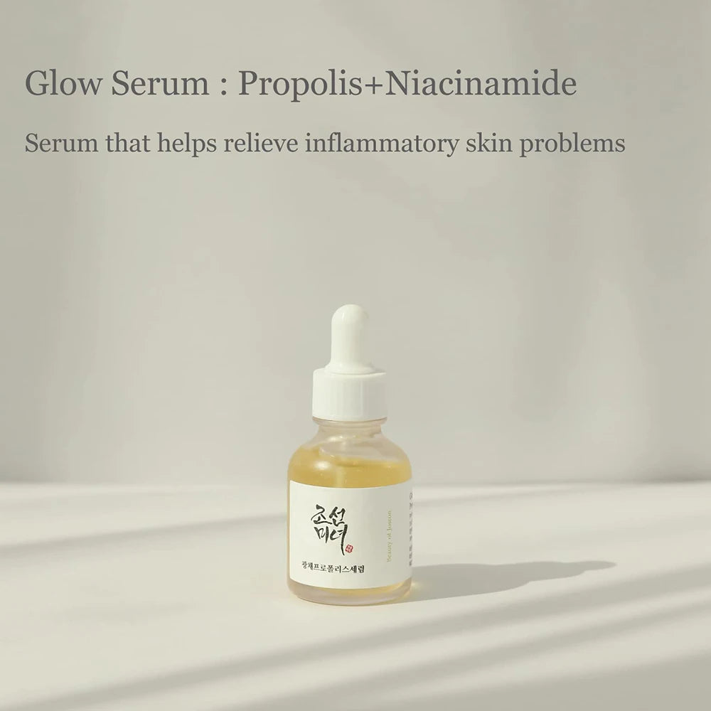 Glow Serum bottle with propolis and niacinamide on a neutral background