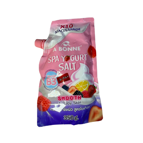 A 550g squeeze pouch of A Bonne Spa Yogurt Salt, Smooth & Baby Skin, featuring a pink and purple design with illustrations of strawberries, raspberries, and a lemon slice, on a plain white background.