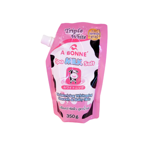 A 350g pink squeeze pouch of A Bonne Spo Milk Salt Triple White moisturizing whitening cream for smooth and baby skin, featuring a cow illustration and black and white cow print details.