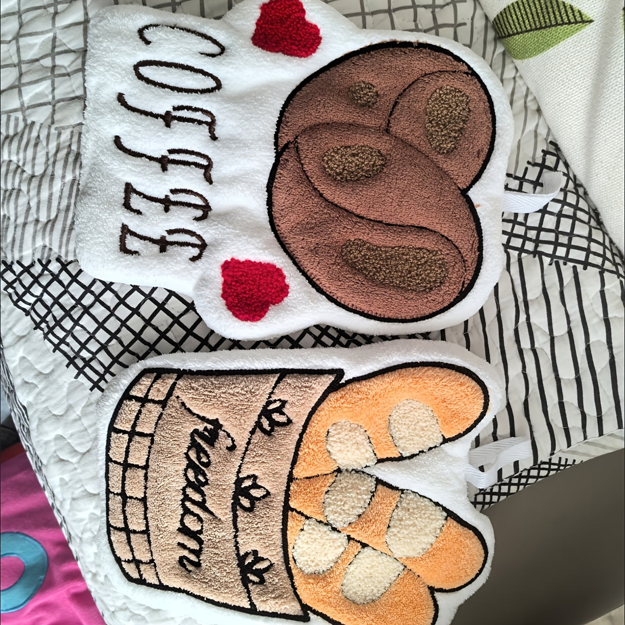 Two embroidered patches with text and designs on a textured fabric background.