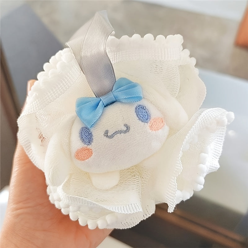 White plush toy with a blue bow held by a hand on a blurred background