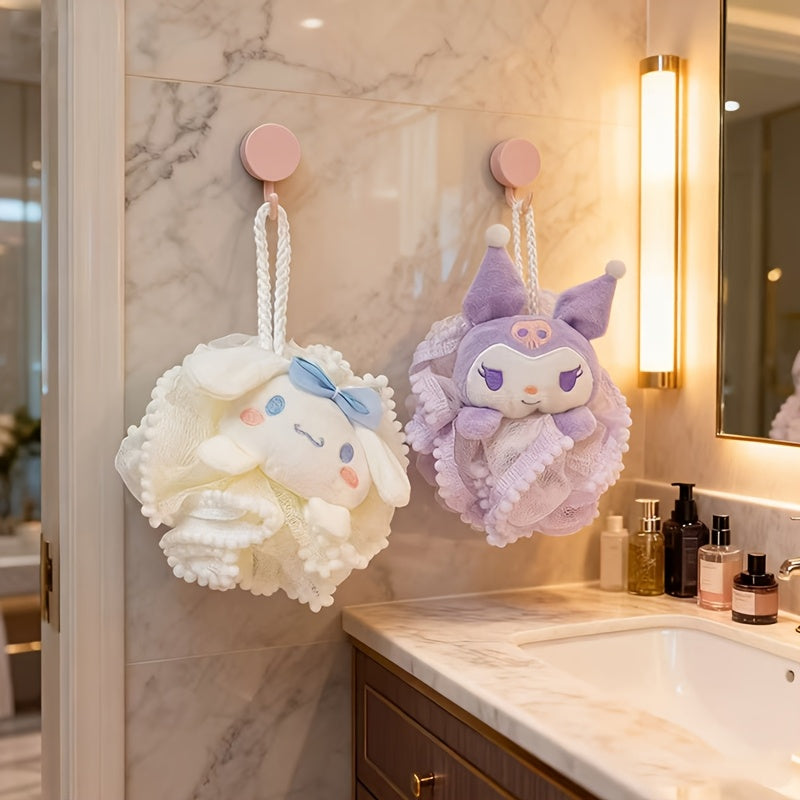 Two cartoon-themed bath poufs hanging on a marble wall above a bathroom sink.