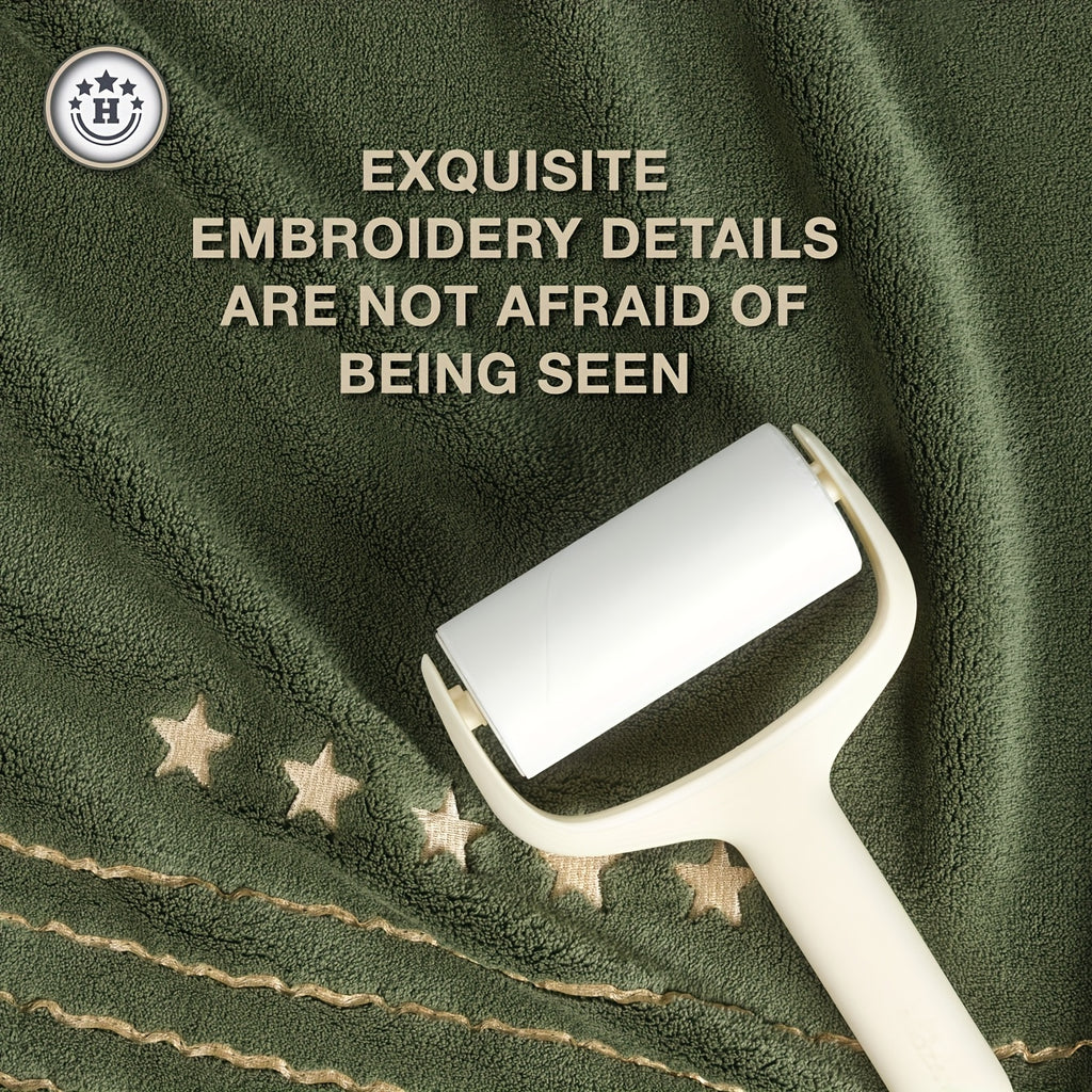 White lint roller on green fabric with embroidered stars and text about embroidery details.